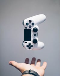 A hand tossing game pad in the air